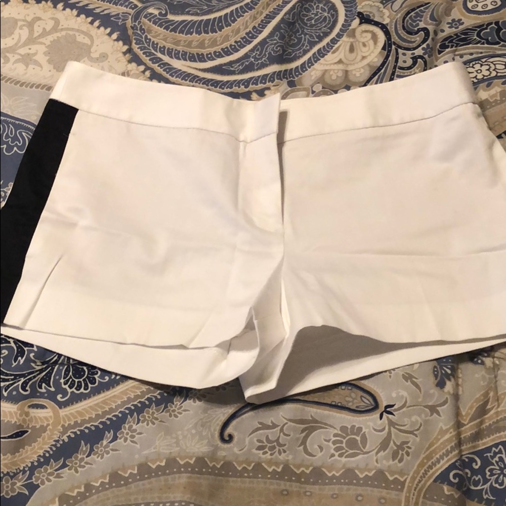 Express- White with black side stripes shorts.